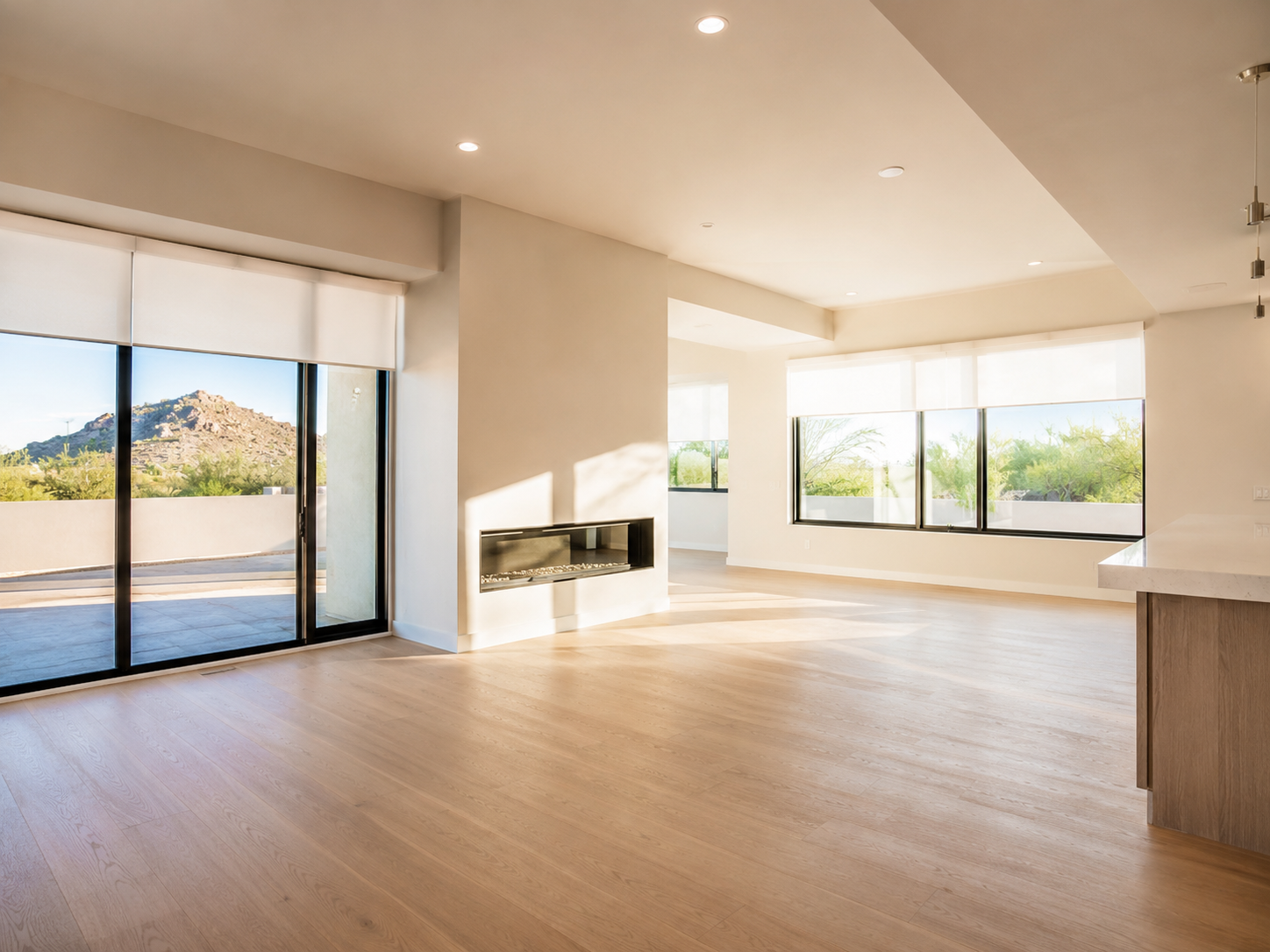 A bright modern interior with custom shades filtering desert light through large windows.